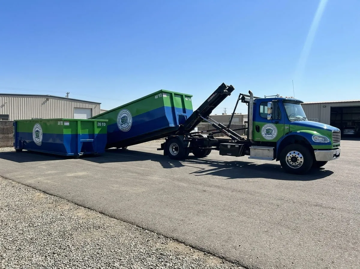 Roll-off truck setting a container down in Visalia, California Roll-off truck setting a container down in Visalia, California