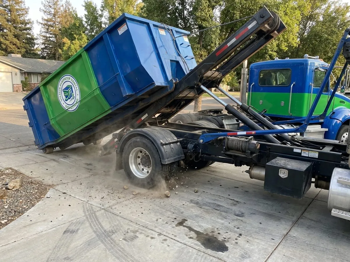 Visalia Dumpster Rental Solutions roll-off truck delivering a dumpster on a street in Visalia, CA Visalia Dumpster Rental Solutions roll-off truck delivering a dumpster on a street in Visalia, CA